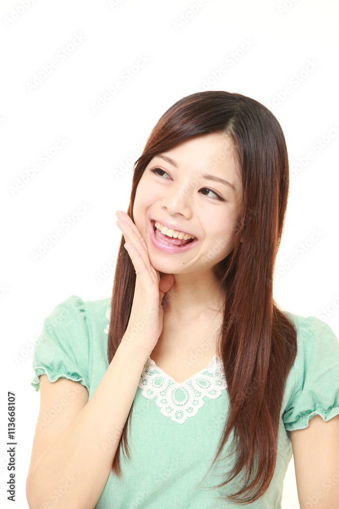 young Japanese woman wearing a green dress pleased young Japanese woman wearing a green dress pleased
