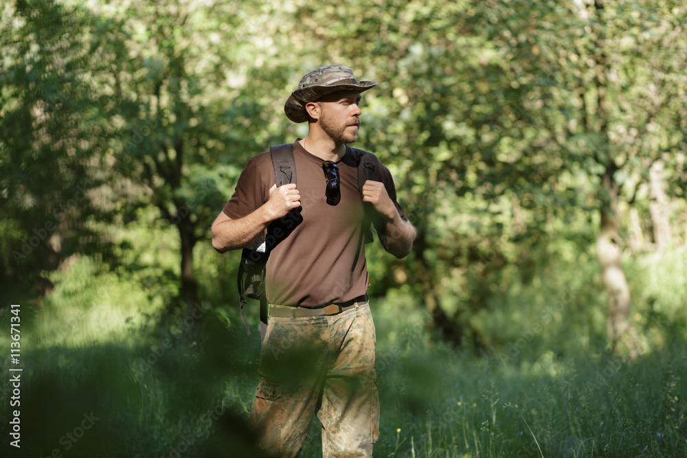 Obraz premium Male tourist walking alone in forest