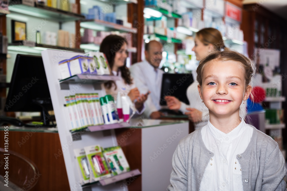 Smiling girl in a pharmacy