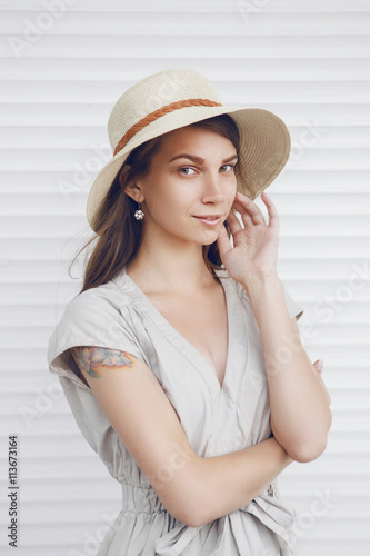 Close up portrait of a smiling young woman with hat