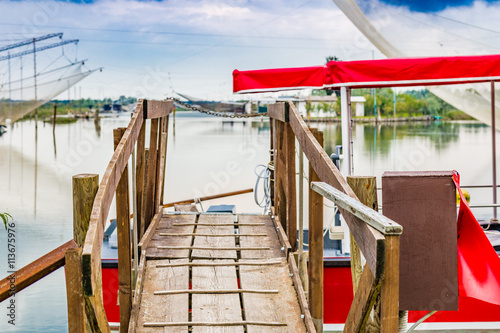 Billede på lærred gangway made of wooden planks in the quiet of brackish lagoon