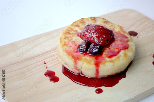 English Crumpets & Berry Topping on wood board isolate on white background photo