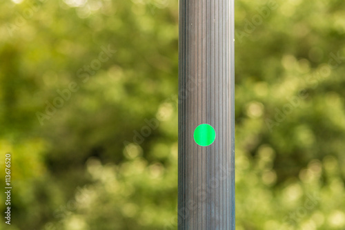 green circular sticker  on pole