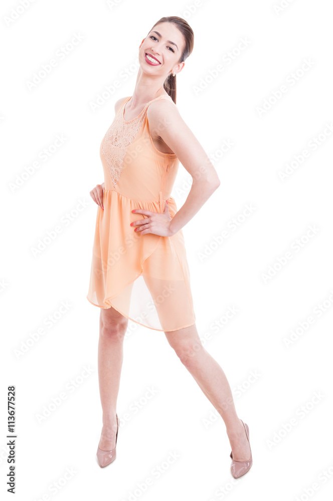 Fototapeta premium Attractive lady posing with shoulder in nude dress and heels