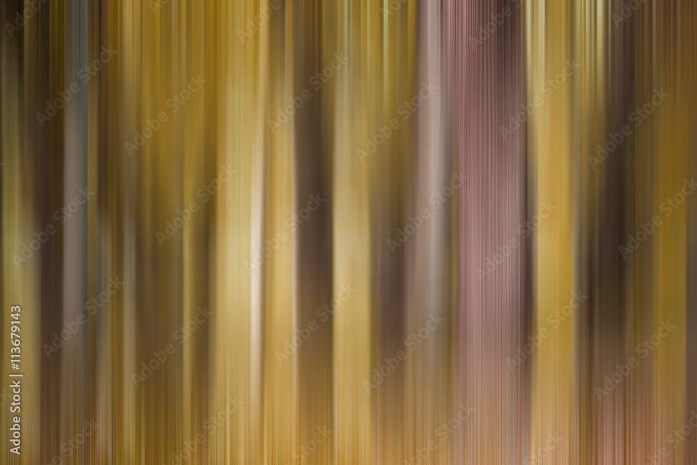 Obraz premium Abstract art for background use. An image of a forest processed with a motion blur effect. The color tone is yellow.