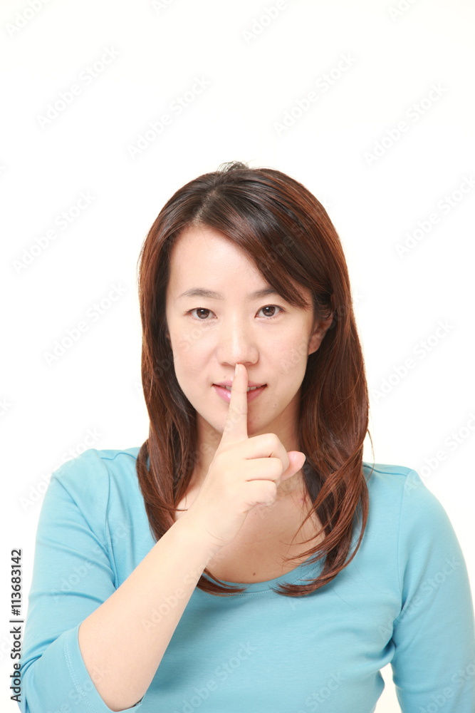 middle aged Japanese woman whith silence gestures middle aged Japanese woman whith silence gestures