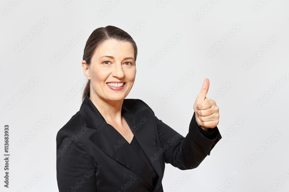 middle aged businesswoman thumbs up middle aged businesswoman thumbs up