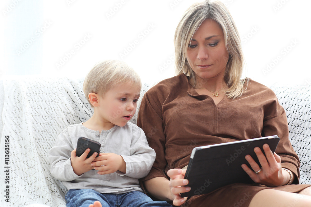 mother and son using electronics mother and son using electronics