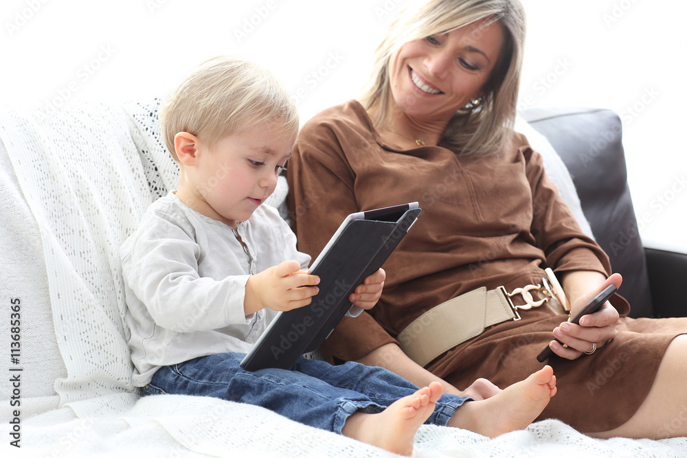 mother and son using electronics mother and son using electronics