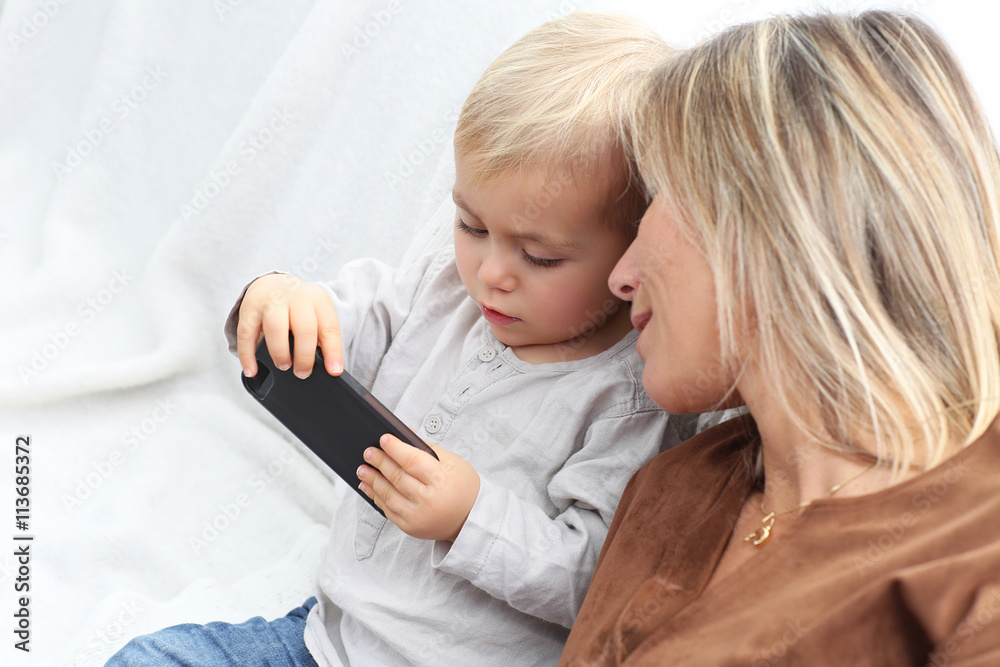 mother and son using mobile phone mother and son using mobile phone