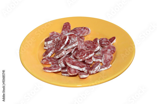 Dish with sliced smoked sausages isolated on white background