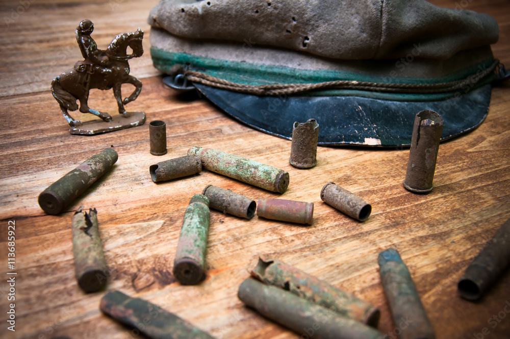Old cartridge shells, various coins and military cap Old cartridge shells, various coins and military cap