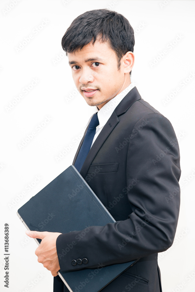 Portrait of young asian business man black suit holding laptop c Portrait of young asian business man black suit holding laptop c