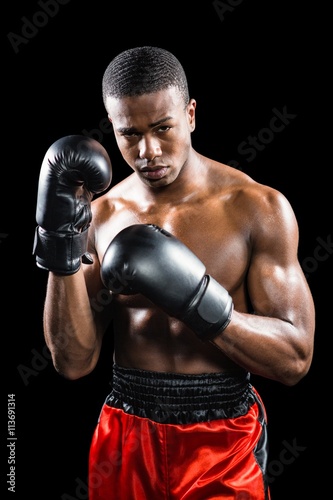 Portrait of boxer performing uppercut