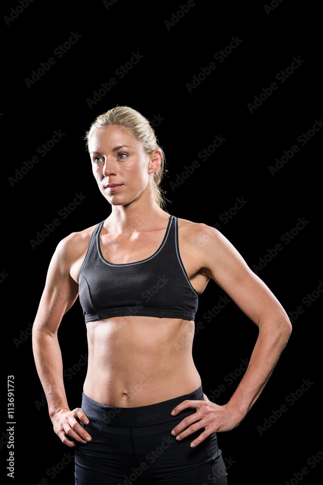 Female athlete standing with hand on hip Female athlete standing with hand on hip