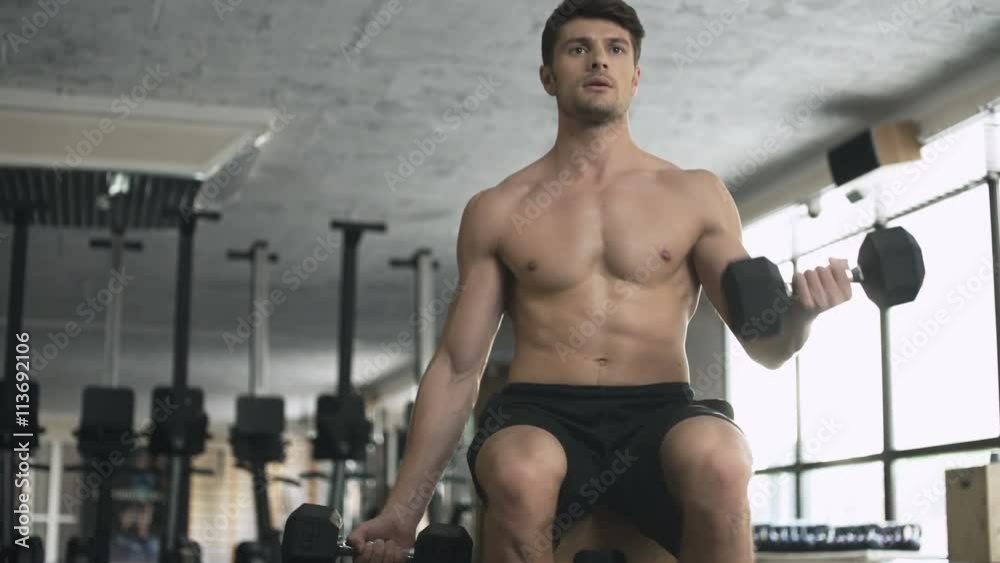 Bodybuilder training his biceps in the gym Bodybuilder training his biceps in the gym