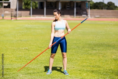 Female athlete holding a javelin in stadium © WavebreakMediaMicro