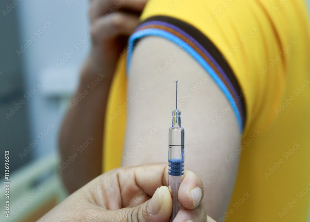 Hand holding syringe for vaccination.Selective focus.Medical concept. Hand holding syringe for vaccination.Selective focus.Medical concept.