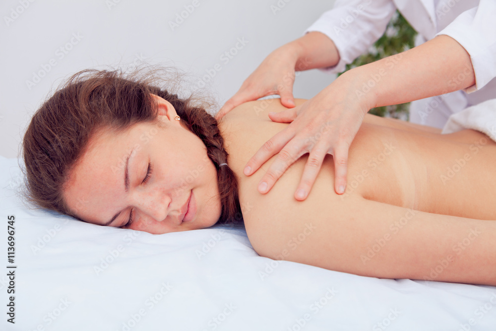 Masseur doing massage on woman body in the spa salon. Beauty treatment concept. Masseur doing massage on woman body in the spa salon. Beauty treatment concept.