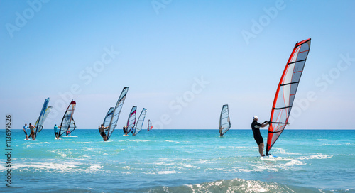 Windsurfing sails on the blue sea photo