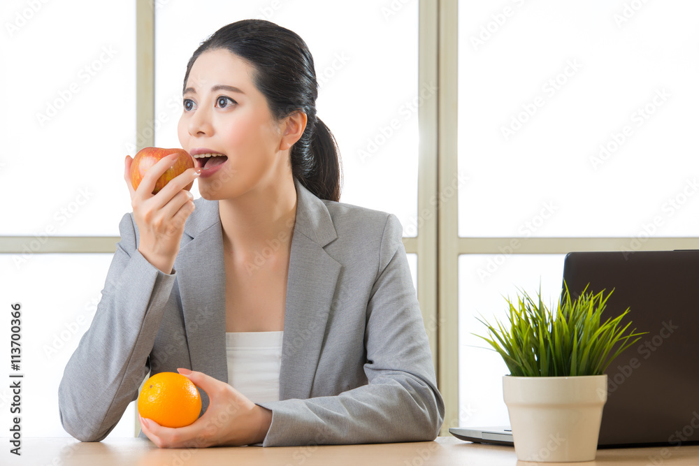 Young asian businesswoman eating healthy snack Young asian businesswoman eating healthy snack