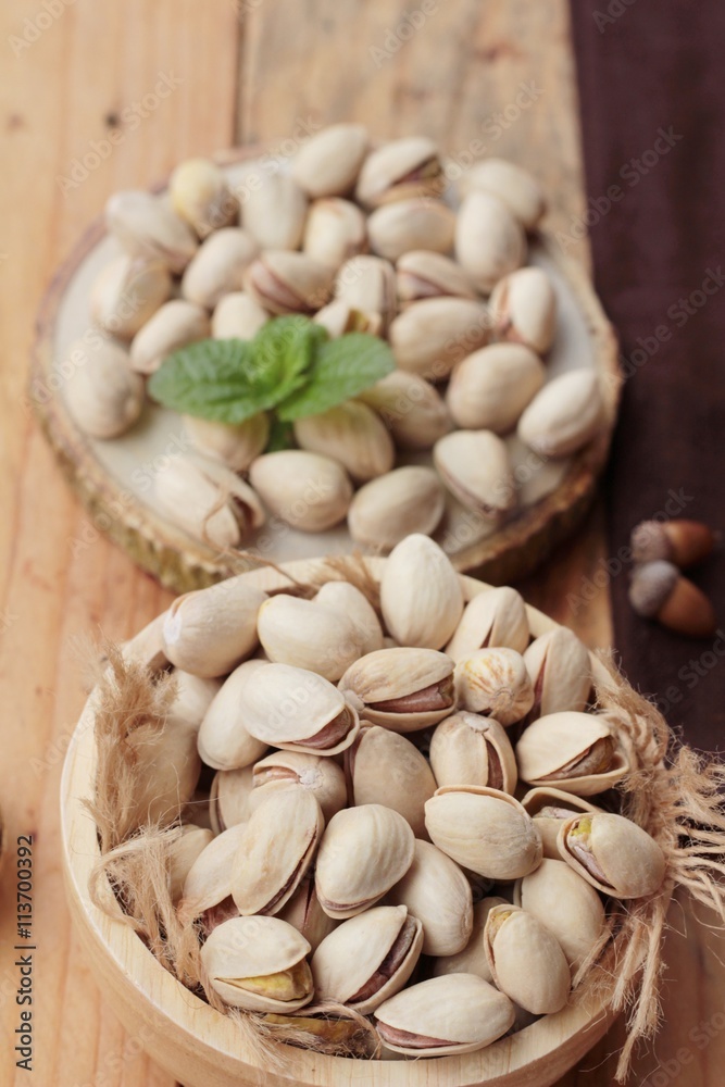 Pistachios is delicious for healthy on wood background. Pistachios is delicious for healthy on wood background.