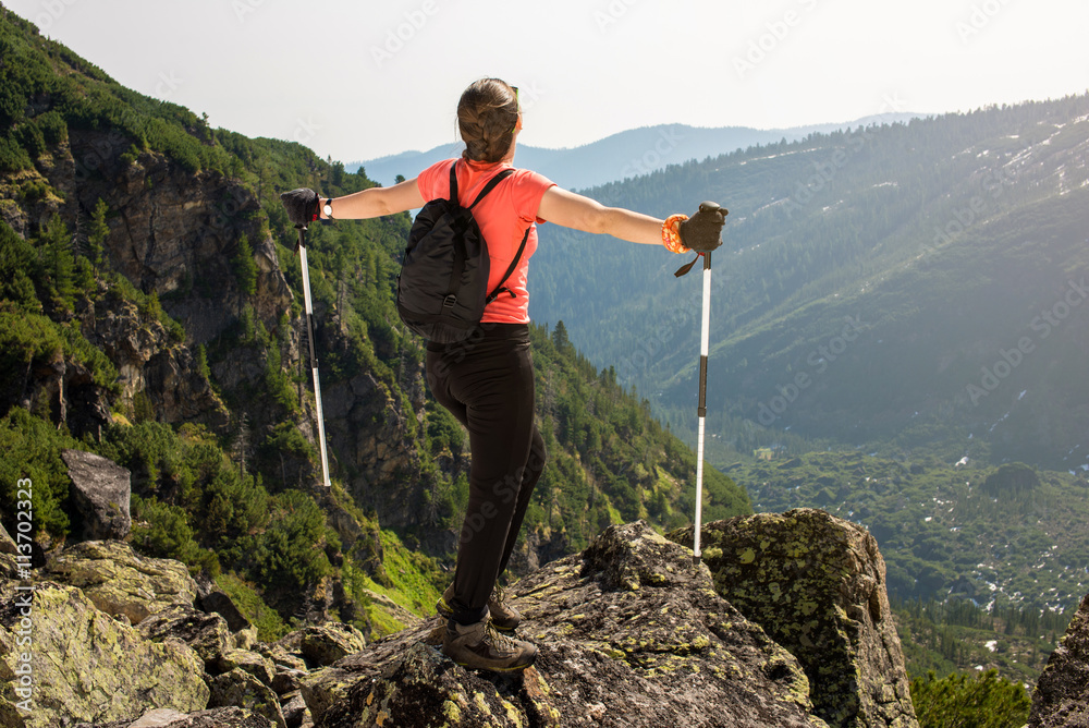 girl celebrates victory in the mountains