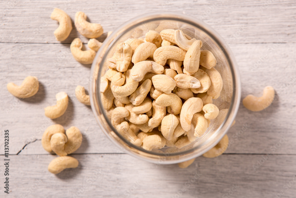 Raw cashew nuts on wooden background, top view Raw cashew nuts on wooden background, top view