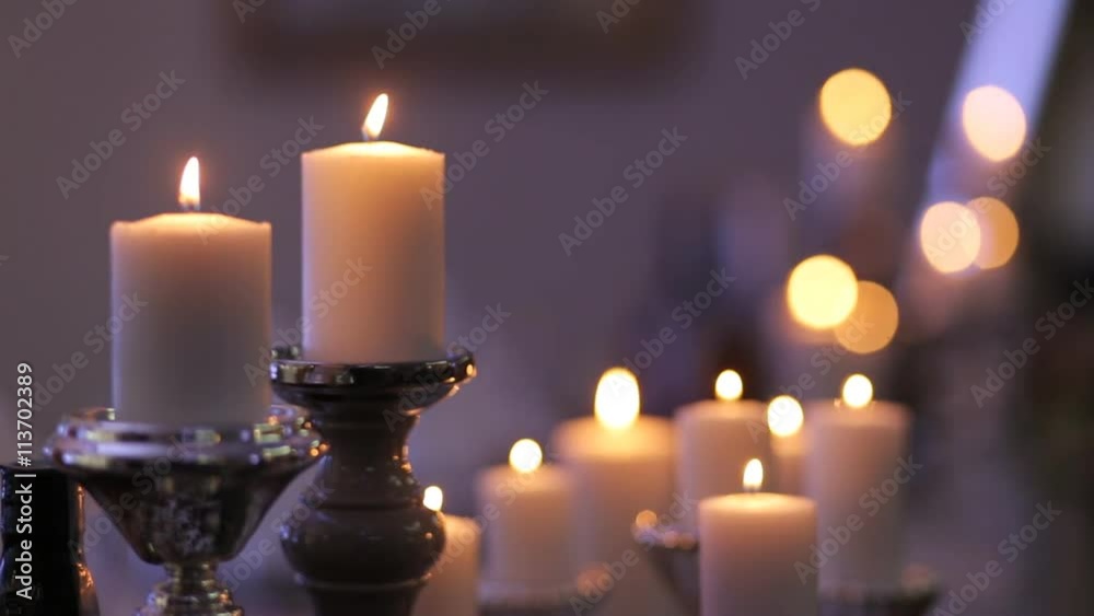 burning candles on old wrought-iron candlestick