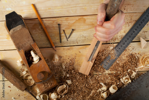Carpenter tools on wood table background. Top view. Copy space