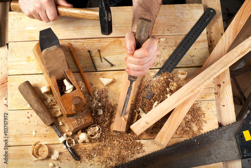 Carpenter tools on wood table background. Top view. Copy space