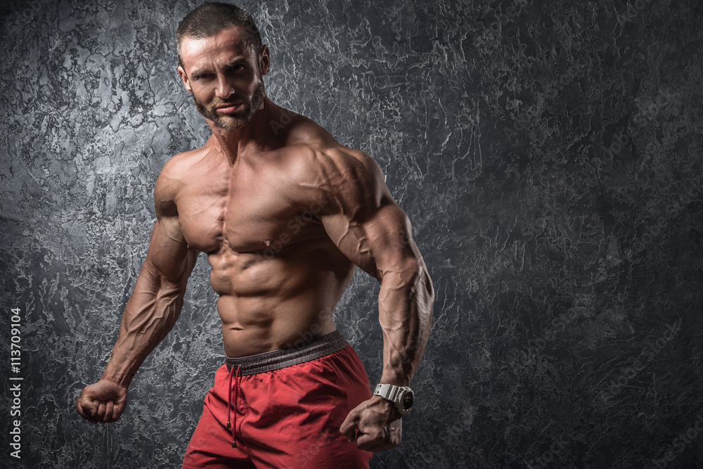 Fototapeta premium Man showing his muscles