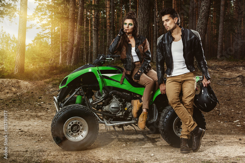 Couple and ATV in the forest