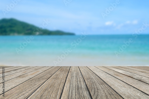 Wood table top with blurred nature scene tropical beach