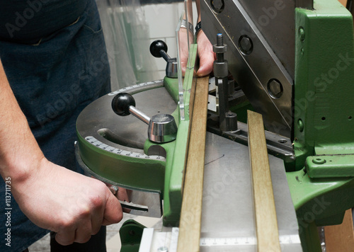 Craftsman working on frame in frameshop.
