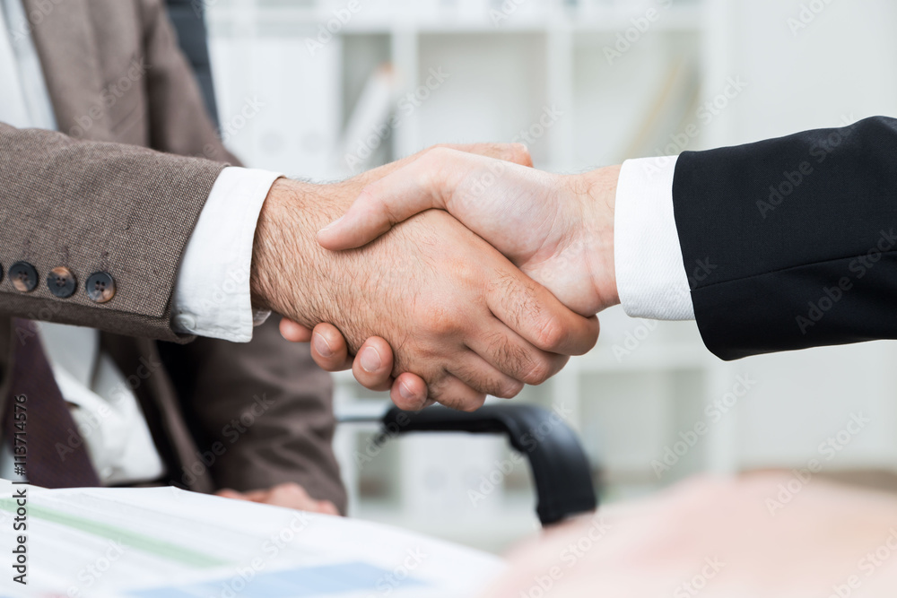 Businessmen shaking hands closeup Businessmen shaking hands closeup