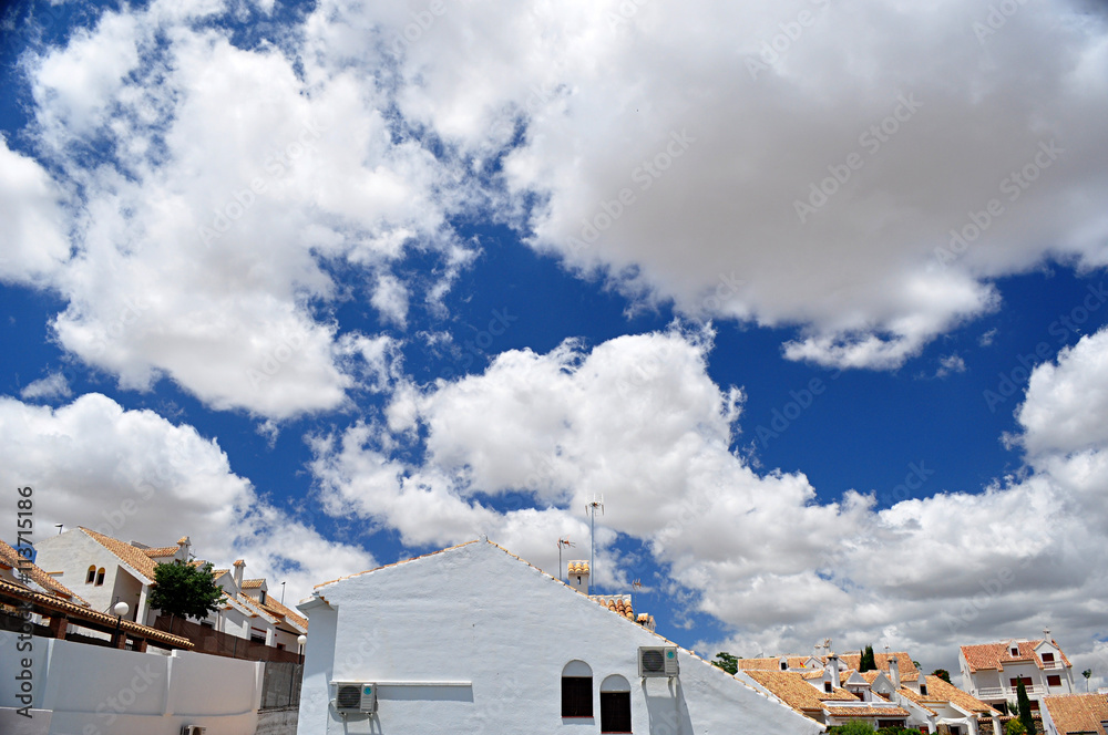 white houses and blue sky with clouds