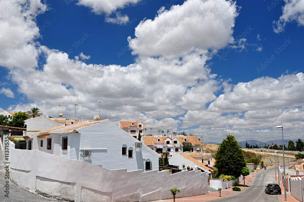 Fototapeta premium white houses and blue sky with clouds
