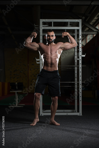 Bodybuilder Performing Front Double Biceps Pose © Jale Ibrak