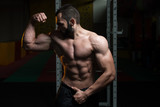 Young Bodybuilder Flexing Muscles Double Biceps Pose
