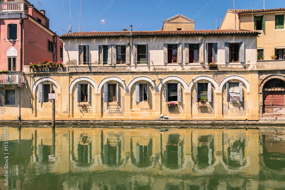 Picturesque buildings on the sides of a canal in Chioggia, Venic