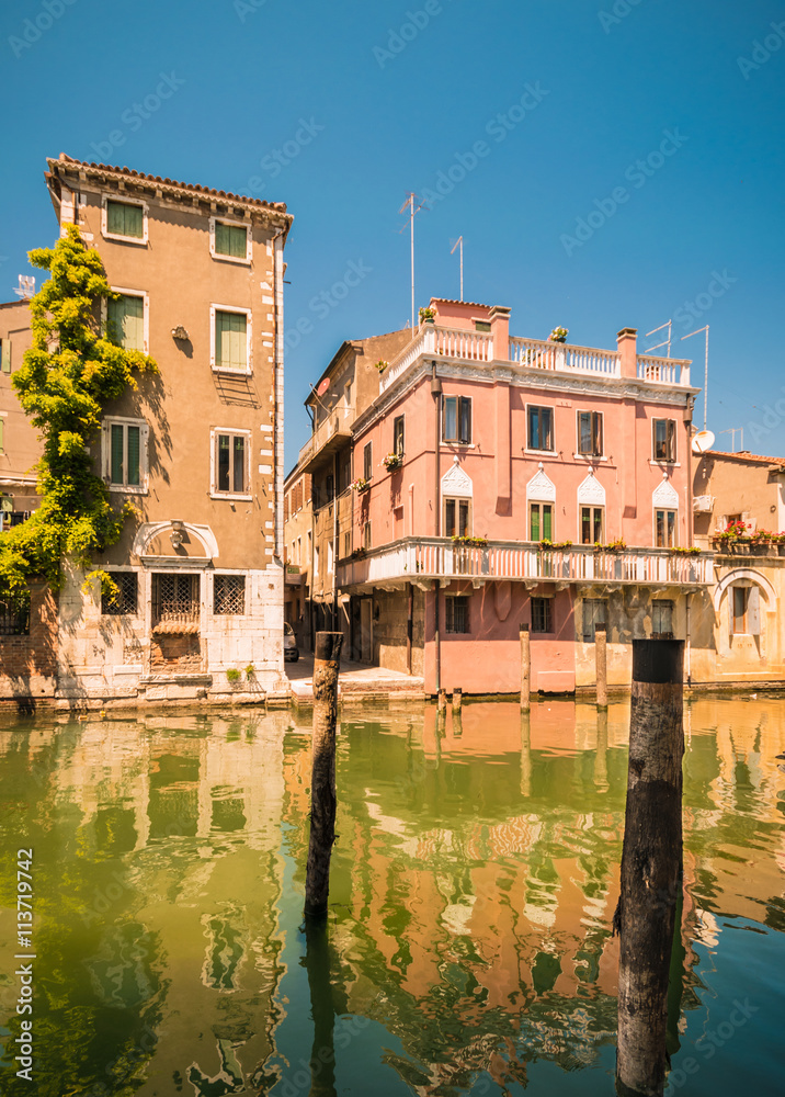 Chioggia houses create colorful reflections in the water of the