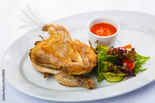 Chicken with sauce and salad