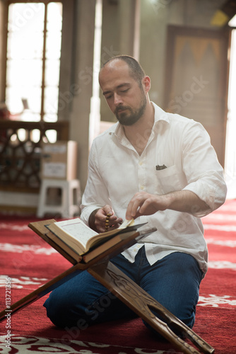 man reading the Koran