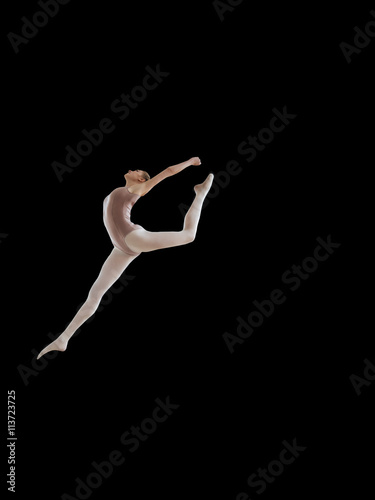 Beautiful ballerina posing in jump on black background