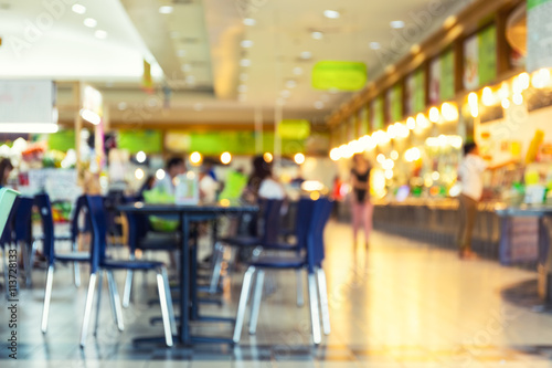 Food court or foodcourt interior blurred background. May called restaurant or canteen include coffee shop with table, people at indoor plaza, mall, store or shopping center in Chiang mai of Thailand.