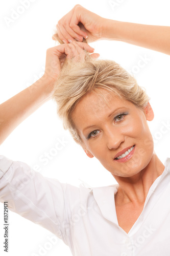portrait mature woman blonde holding her long hair