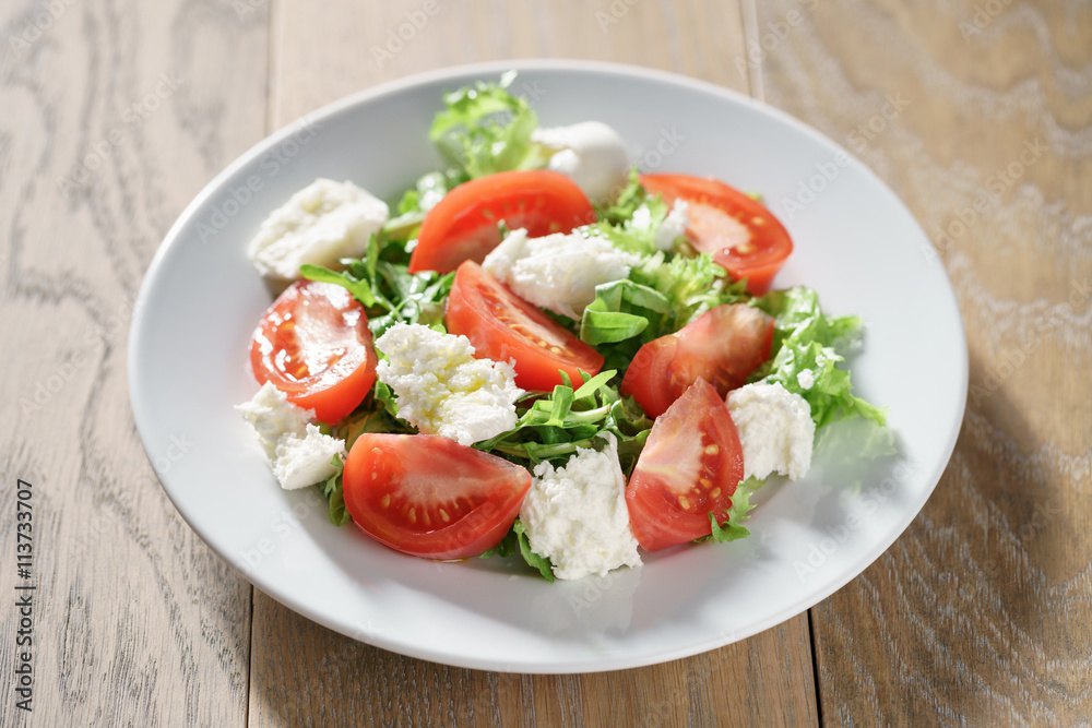 summer light salad with tomatoes, mozzarella and rocket leaves summer light salad with tomatoes, mozzarella and rocket leaves