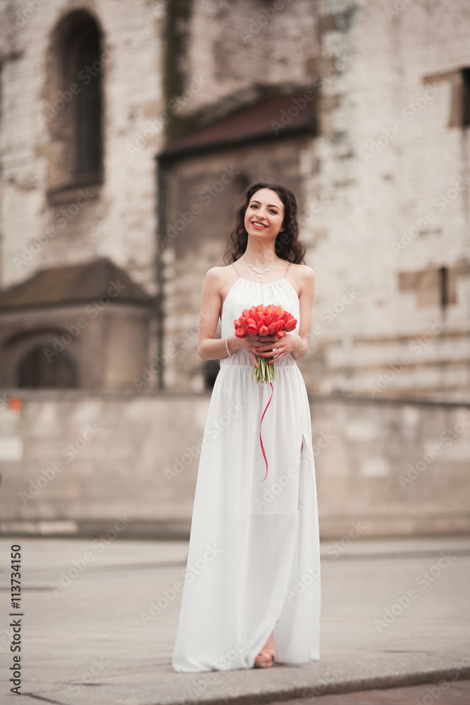 Beautiful young bride with bridal bouquet on the background church