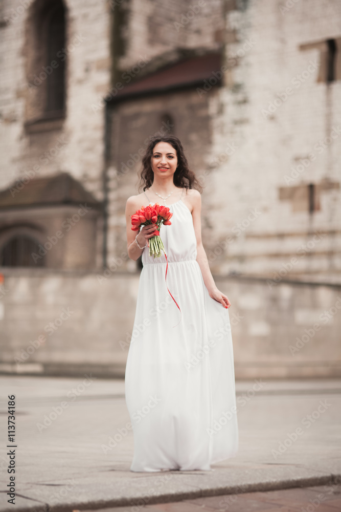 Beautiful young bride with bridal bouquet on the background church